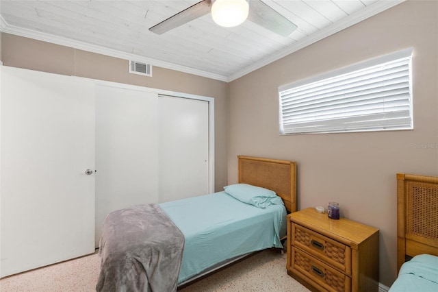 bedroom featuring a closet, ceiling fan, and ornamental molding