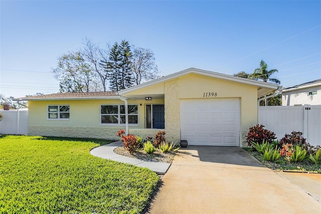 single story home featuring a garage and a front yard