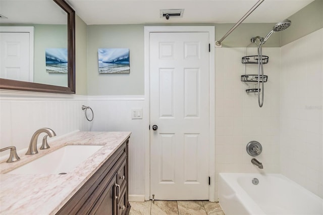 bathroom with vanity and tiled shower / bath combo