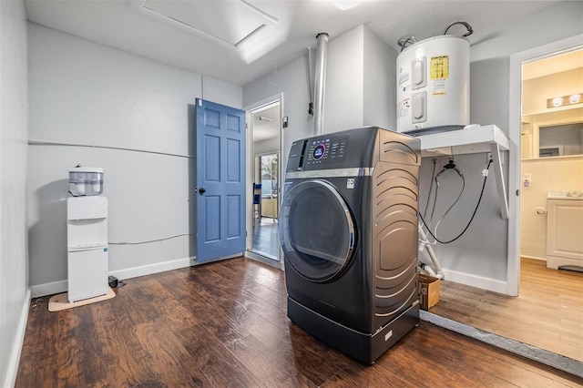 laundry room with washer / clothes dryer, dark hardwood / wood-style floors, and water heater