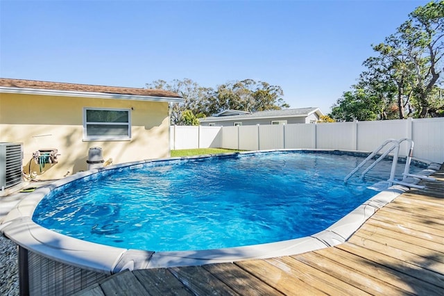 view of swimming pool with a deck