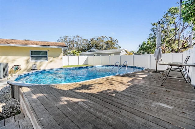 view of swimming pool with a wooden deck and central AC