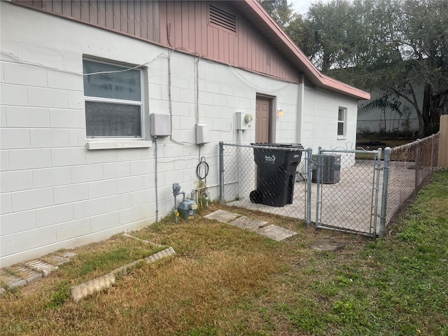 view of side of property with cooling unit and a lawn