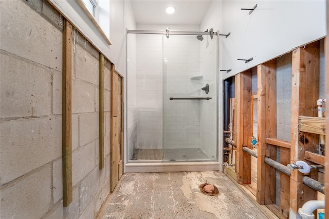 bathroom featuring a shower with shower door