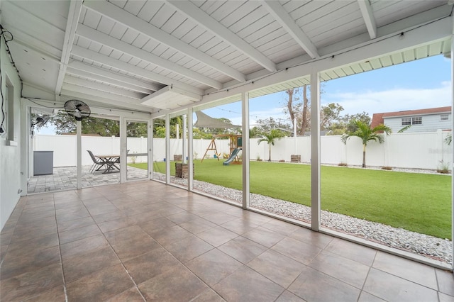 unfurnished sunroom with vaulted ceiling with beams