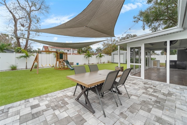 view of patio / terrace featuring a playground and an outbuilding