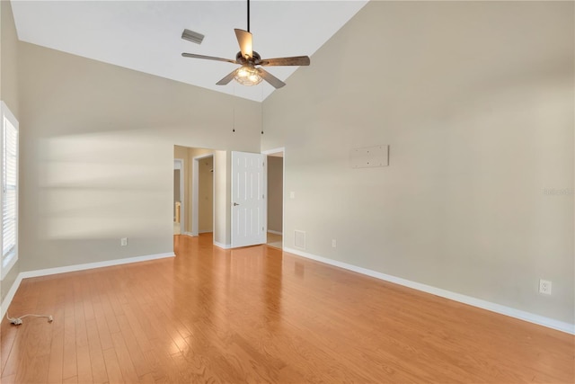 unfurnished room with a healthy amount of sunlight, high vaulted ceiling, ceiling fan, and light hardwood / wood-style floors