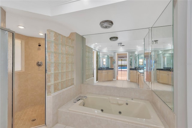 bathroom with tile patterned flooring, independent shower and bath, and vanity