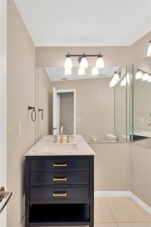 bathroom featuring tile patterned flooring and vanity