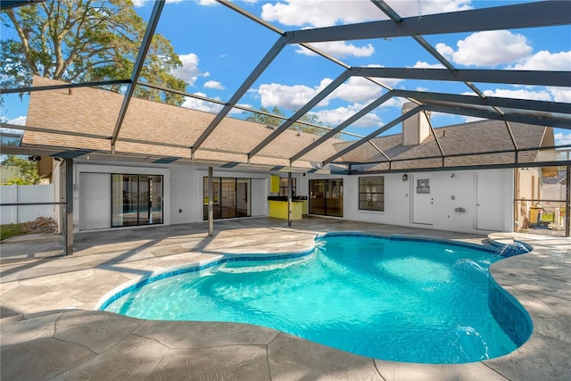 view of swimming pool with a lanai and a patio area