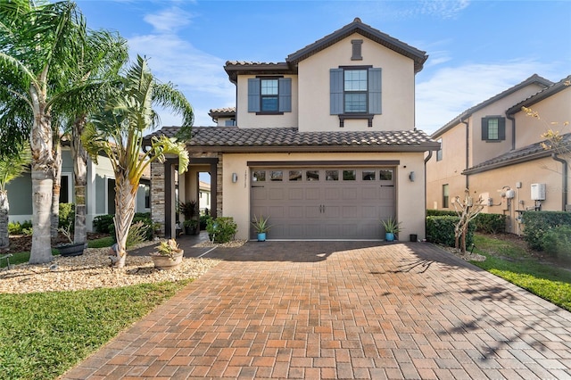 mediterranean / spanish-style home with a garage