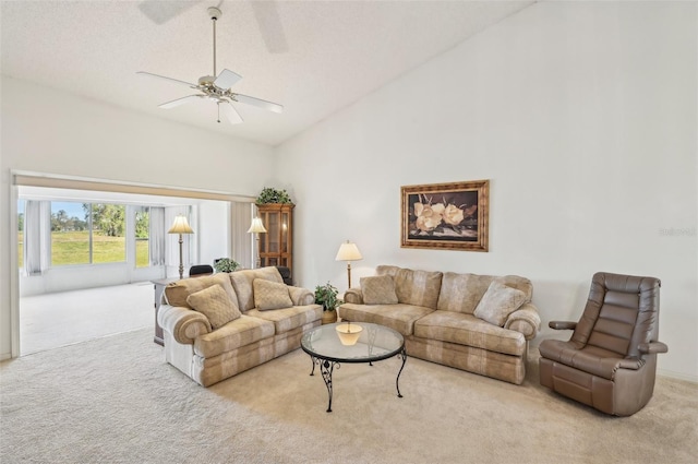 carpeted living room with high vaulted ceiling and ceiling fan