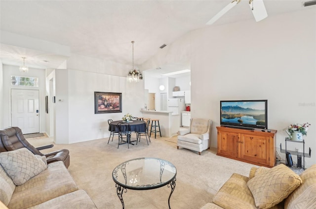 living room featuring light carpet, lofted ceiling, and ceiling fan with notable chandelier