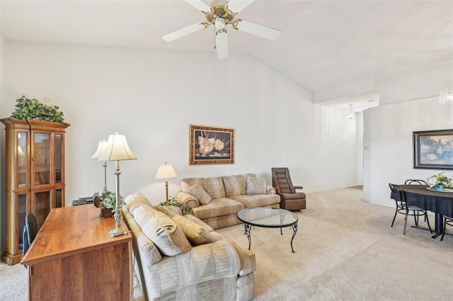 living room featuring ceiling fan, vaulted ceiling, and light colored carpet