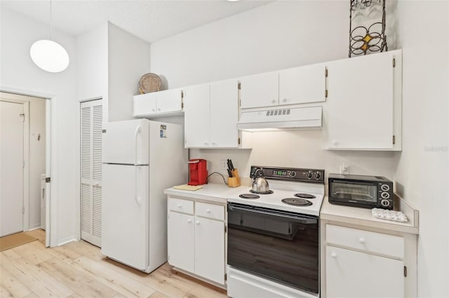 kitchen with decorative light fixtures, white cabinets, white fridge, light hardwood / wood-style flooring, and range with electric stovetop