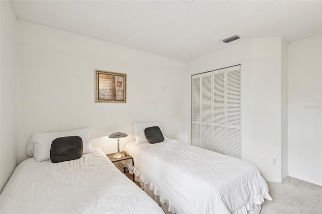 bedroom with a closet and carpet