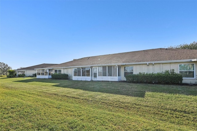 rear view of property with a lawn