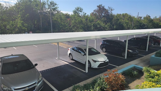 view of parking / parking lot featuring a carport