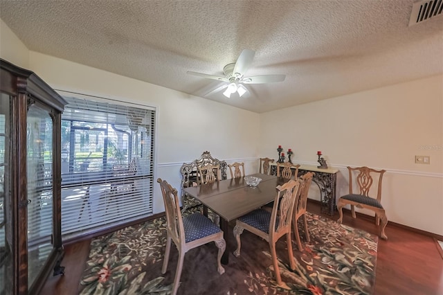 dining room with a textured ceiling, wood-type flooring, and ceiling fan