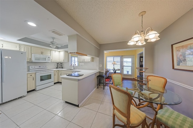 kitchen featuring pendant lighting, white appliances, backsplash, a tray ceiling, and kitchen peninsula