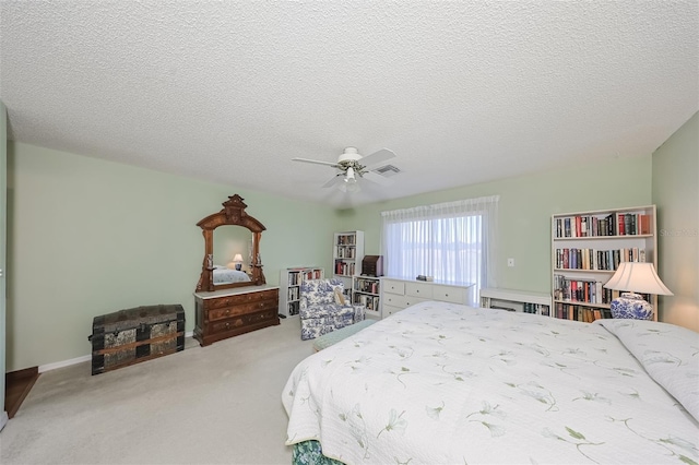 bedroom featuring a textured ceiling, ceiling fan, and carpet flooring