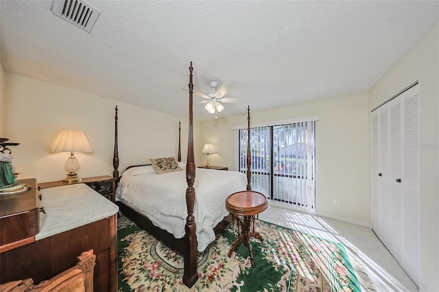 bedroom with a textured ceiling, access to outside, a closet, ceiling fan, and carpet