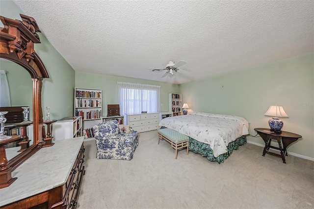 bedroom featuring carpet floors, a textured ceiling, and ceiling fan