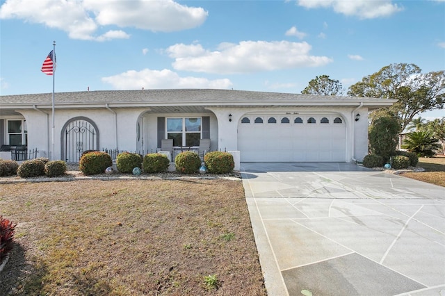 ranch-style home with a garage and a front lawn