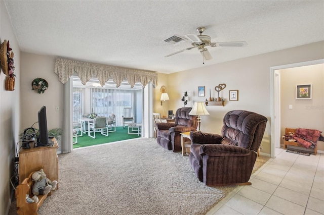 living room featuring light tile patterned flooring, a textured ceiling, and ceiling fan