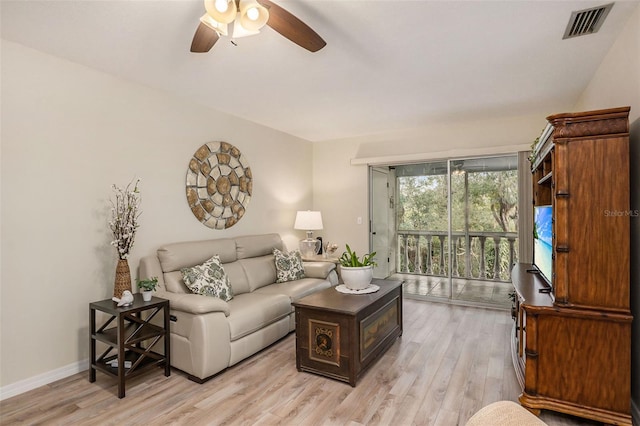 living room with ceiling fan and light wood-type flooring