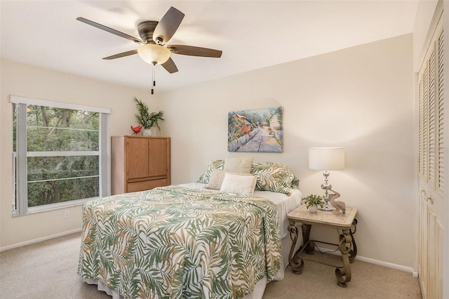 bedroom featuring light carpet, a closet, and ceiling fan