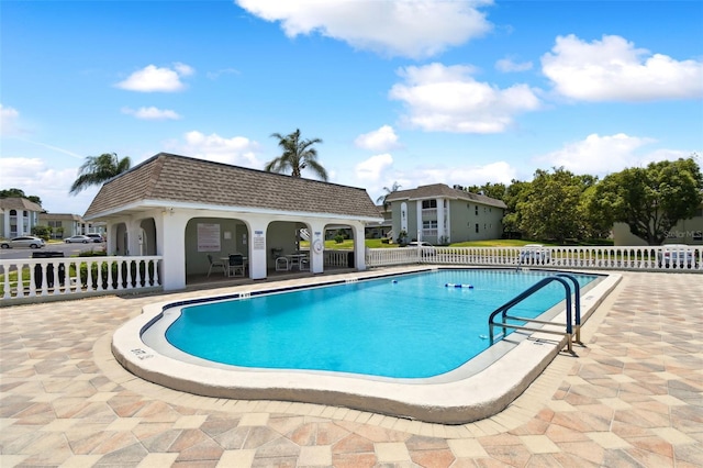 view of pool featuring a patio area and an outdoor structure