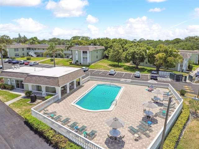 view of swimming pool with an outdoor structure and a patio area