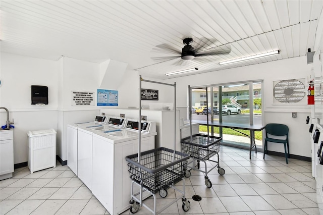 laundry area featuring washing machine and clothes dryer, ceiling fan, and light tile patterned floors