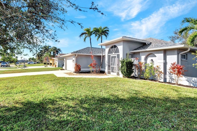 view of front of house with a front lawn and a garage