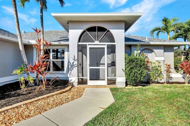 doorway to property featuring a yard