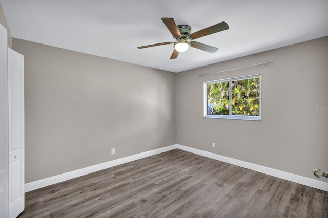 spare room with hardwood / wood-style floors and ceiling fan