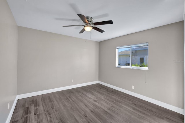 spare room featuring ceiling fan and dark wood-type flooring