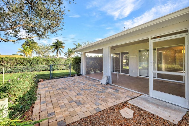 view of patio featuring a sunroom