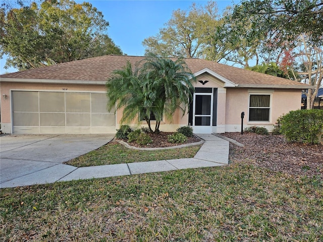 ranch-style home with roof with shingles, a garage, driveway, and stucco siding