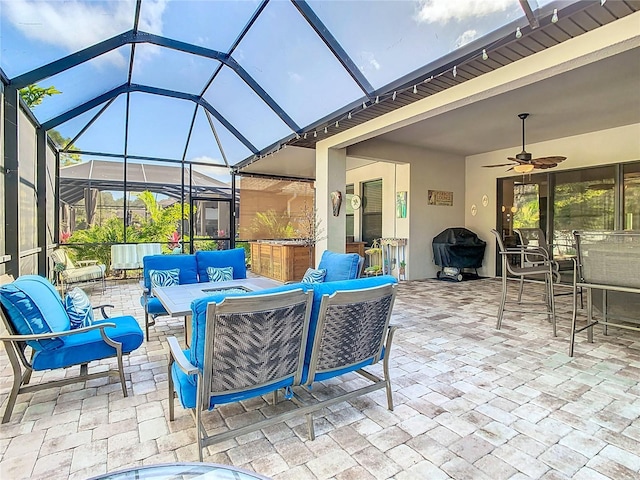 view of patio / terrace featuring an outdoor living space, ceiling fan, glass enclosure, area for grilling, and an outdoor bar