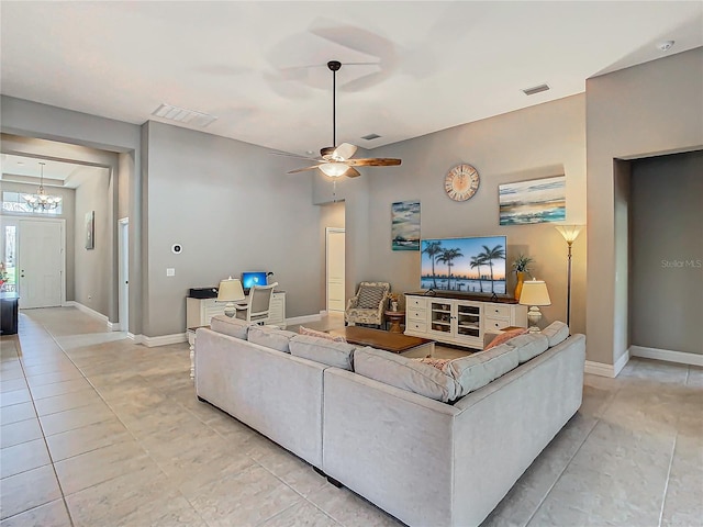 tiled living room with ceiling fan