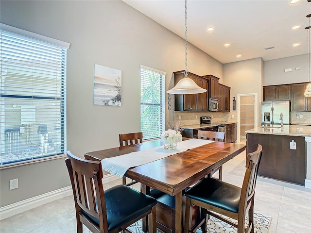 dining area featuring sink and light tile patterned floors