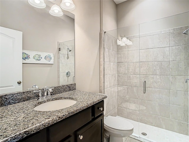 bathroom with walk in shower, vanity, and toilet