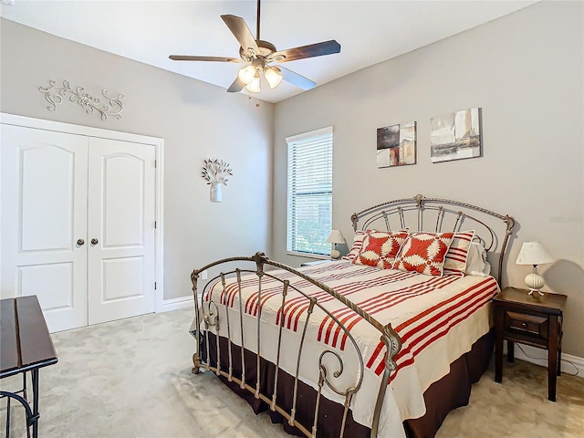 carpeted bedroom featuring a closet and ceiling fan