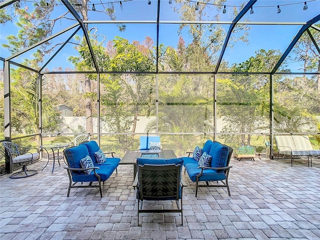 view of patio with glass enclosure and an outdoor living space