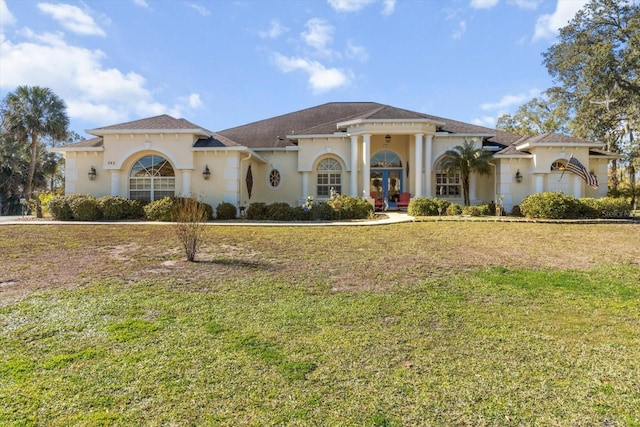 mediterranean / spanish home featuring a front lawn