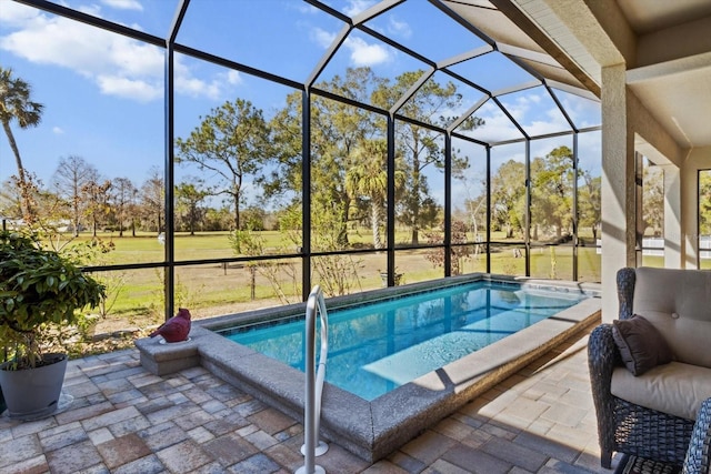 view of pool featuring glass enclosure and a patio