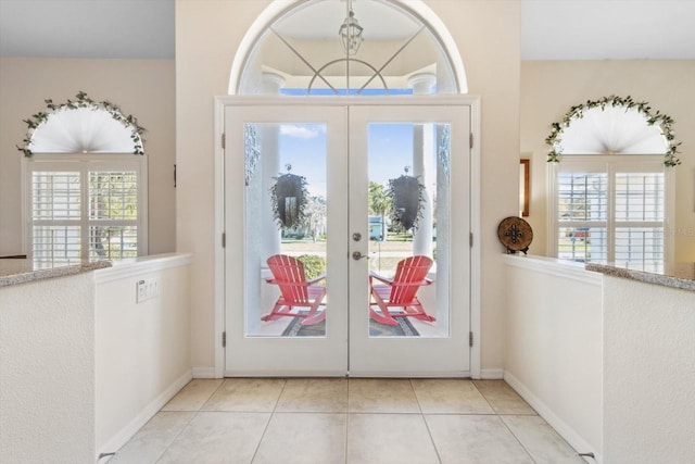 entryway with french doors and light tile patterned floors