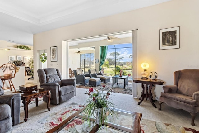 carpeted living room with ceiling fan